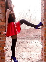 Cool Nymph Posing Outdoors In Red Mini Skirt & Blue Shiny Ankle Boots