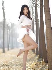Beautiful Oriental Dressed In White Lifting Her Skirt